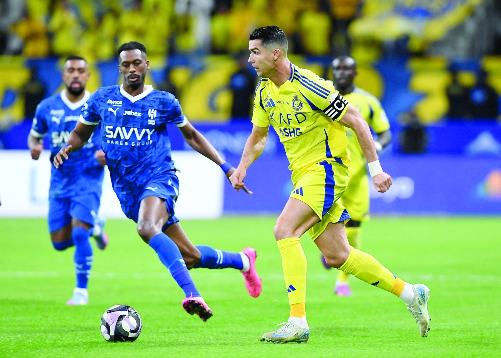 Al Nassr's Cristiano Ronaldo in action with Al Hilal's Mohammed Kanno.— Reuters