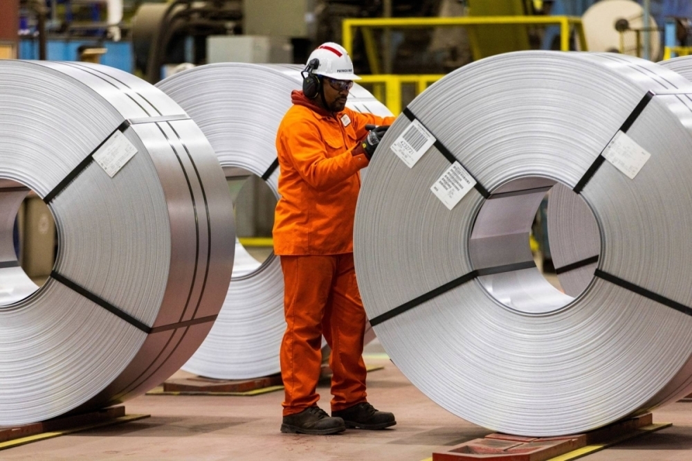A worker inspects a steel coil on the factory floor before Canada's Prime Minister-designate Mark Carney visits the ArcelorMittal Dofasco steel mill in Hamilton, Ontario, Canada. — Reuters