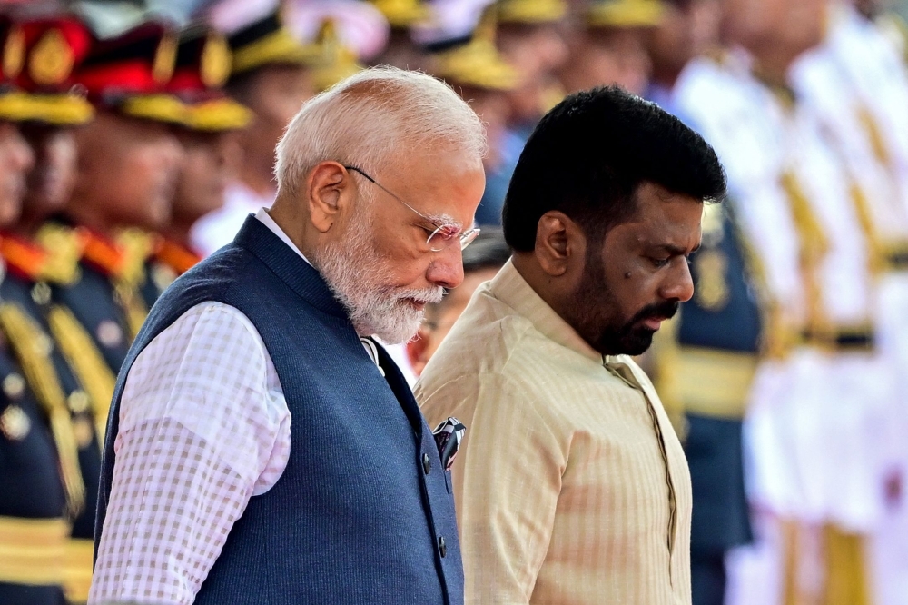 India's PM Narendra Modi (L) walks alongside Sri Lanka's President Anura Kumara Dissanayake, at the Independence Square in Colombo. — AFP
