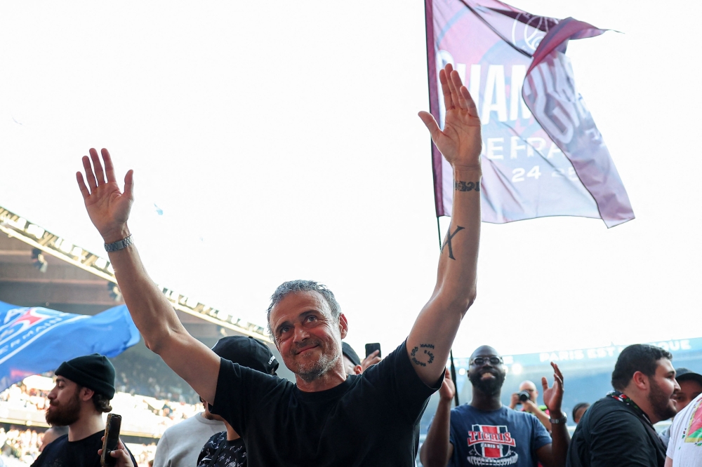 Paris Saint-Germain's Spanish head coach Luis Enrique celebrates after winning the match. — AFP