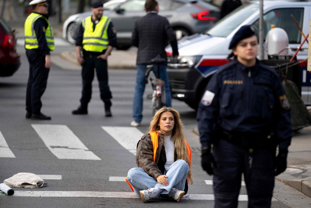 German activist Anja Windl of environmental movement Last Generation blocks the traffic with fellow activists at Aspern bridge on April 03, 2023 in Vienna, Austria. Austria has banned the German climate activist Anja Windl for two years, she said on April 7, 2025, adding she would fight the ban, which could see her expelled from the Alpine EU member. The activist, who has lived in Austria for seven years, became known for her protests against climate change, including gluing herself on streets to stop traffic with the Last Generation (Letzte Generation) group. (Photo by JOE KLAMAR / AFP)

