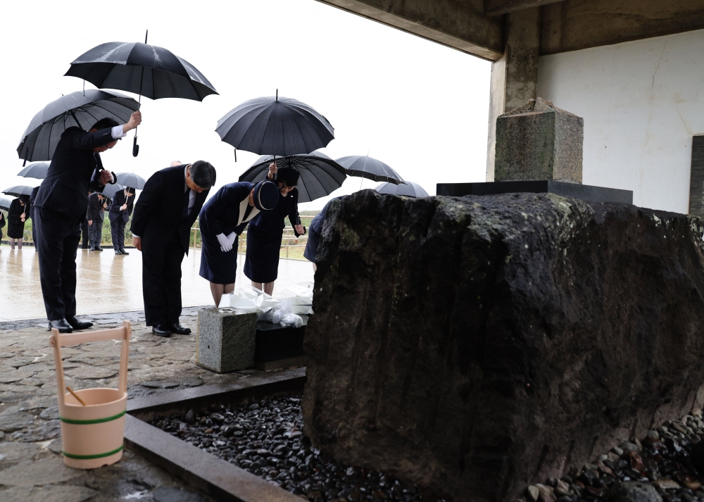 Japan's Emperor Naruhito and Empress Masako bow