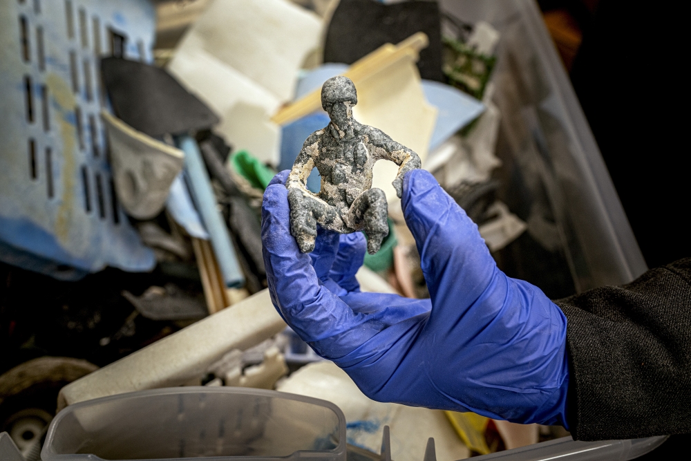 Researcher Marcus Garcia shows a plastic toy that was collected from a Hawaii beach in a lab at the University of New Mexico in Albuquerque on March 4, 2025. (Gabriela Campos/The New York Times)