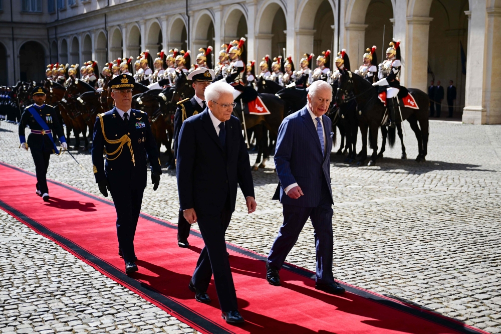 Italy's President Sergio Mattarella (L) and Britain's King Charles III inspect a Guard of Honour at the Quirinale Presidential Palace in Rome. — AFP