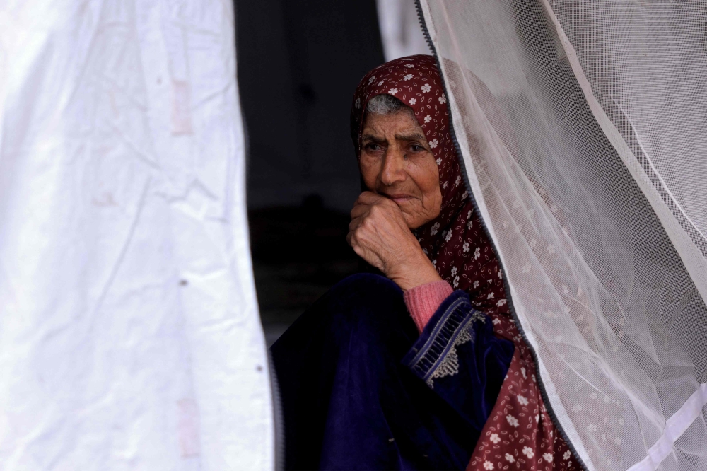A woman looks on from inside her tent at the Jabalia camp for displaced Palestinians in the northern Gaza Strip on April 8, 2025. 
 Israel resumed major strikes on the Gaza Strip on March 18, ending a two-month ceasefire with Hamas. (Photo by Bashar TALEB / AFP)
