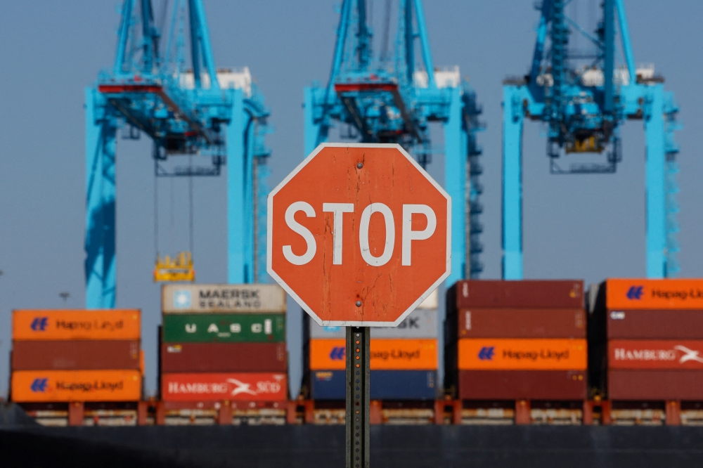 A cargo ship sits outside of the Port of Elizabeth marine terminal seen from Bayonne, New Jersey