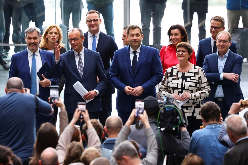 Germany's chancellor-in-waiting and leader of the Christian Democratic Union party (CDU) Friedrich Merz and attend a press conference after reaching an agreement on their coalition government in Berlin