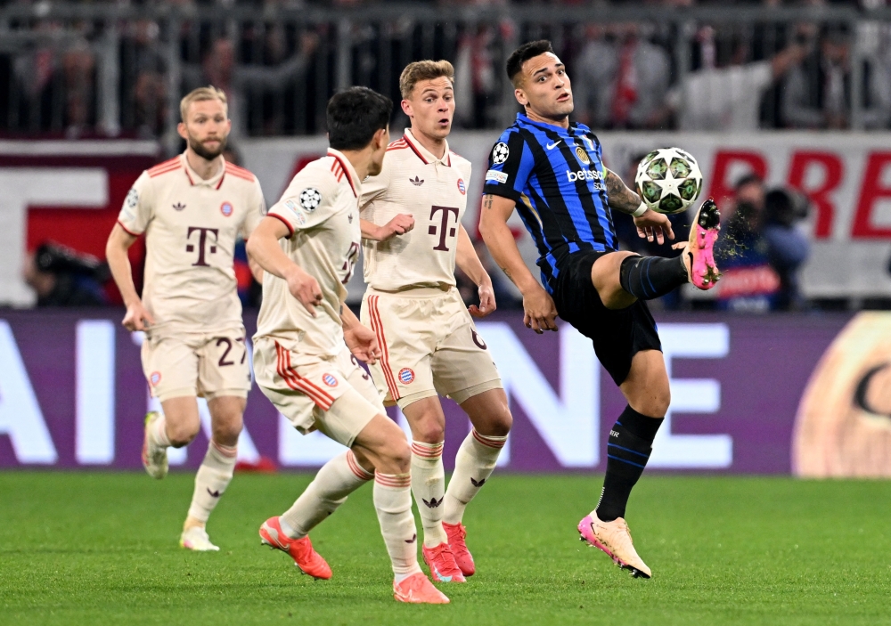 Bayern Munich's Joshua Kimmich in action with Inter Milan's Lautaro Martinez. — Reuters
