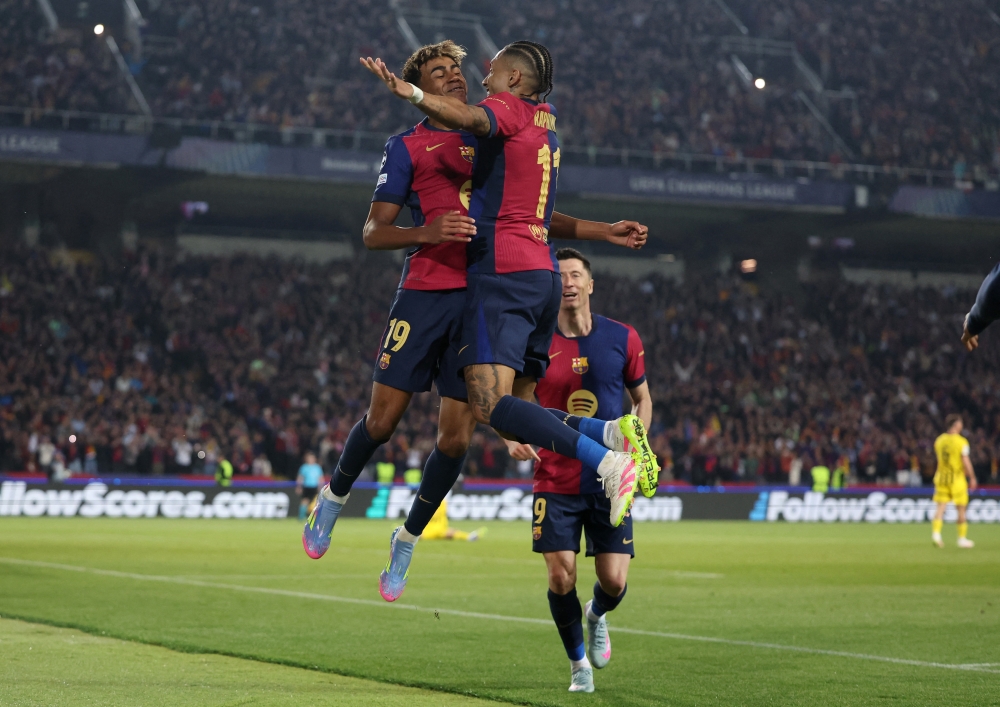 FC Barcelona's Lamine Yamal celebrates scoring their fourth goal with Raphinha. — Reuters