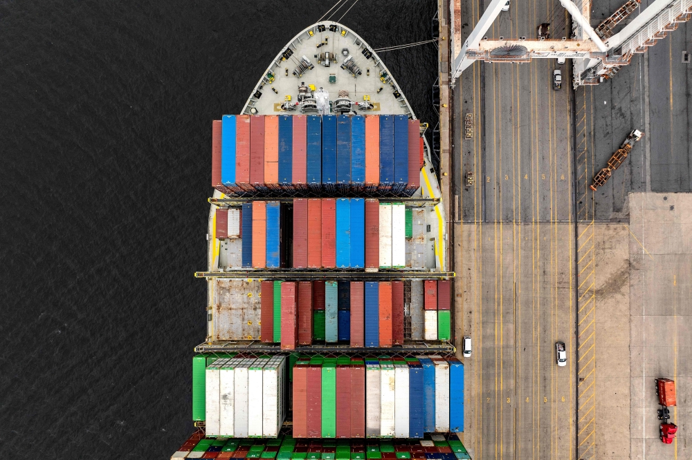 A cargo ship carrying shipping containers is moored to the pier at the Port of Baltimore on Thursday in Baltimore, Maryland.