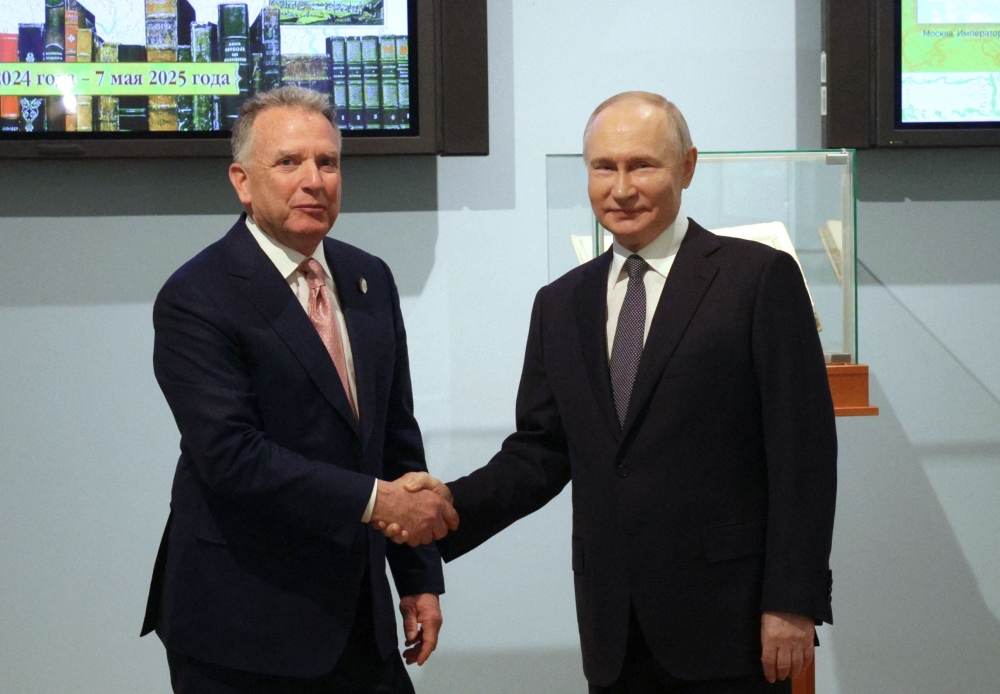 Russia's President Vladimir Putin shakes hands with US President Donald Trump's envoy Steve Witkoff during a meeting in Saint Petersburg. - AFP


