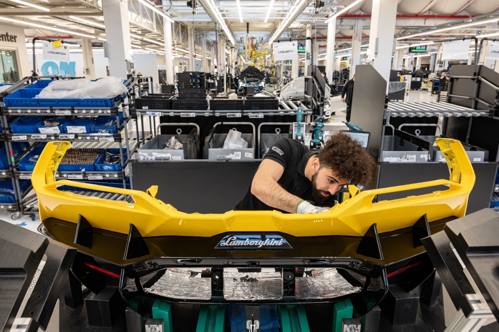 An employee works on a bumper section of a car on the production line at the Lamborghini factory in Sant'Agata Bolognese, Italy, in February 2025. (Federico Borella/The New York Times)