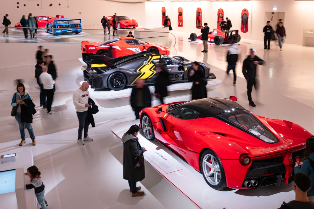 Visitors look at cars on display at the Ferrari Museum in Modena, Italy, in February 2025. (Federico Borella/The New York Times)