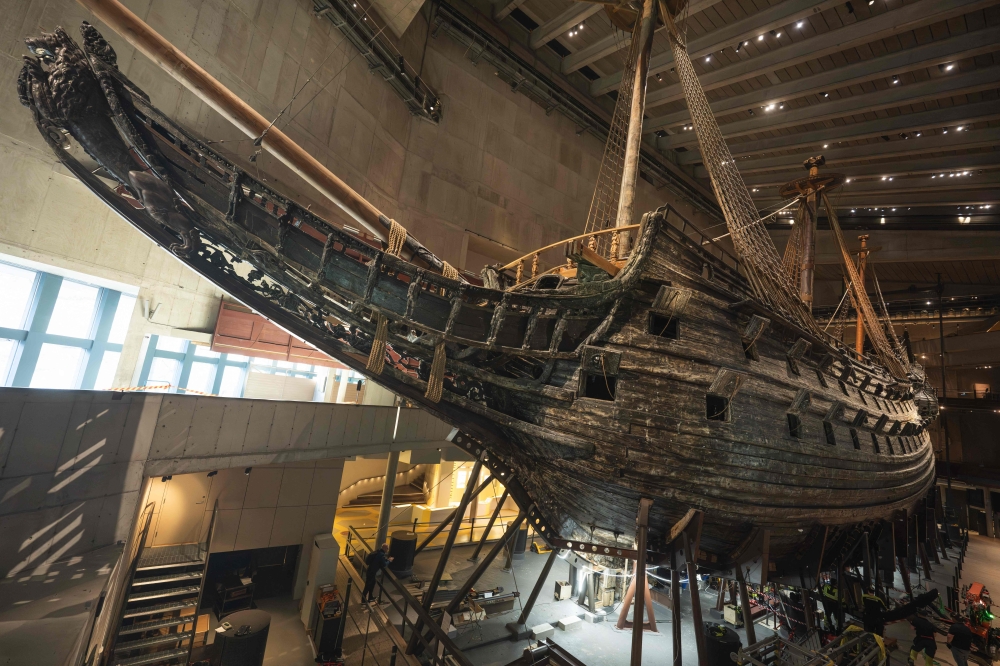 Workers install a new metallic support structure for the 17th-century warship Vasa at the Vasa Museum in Stockholm, Sweden, on April 8, 2025. The new structure will replace the current one, which has been damaging the ship over time. The royal warship Vasa sank in 1628 and was salvaged more than 300 years later. (Photo by Jonathan NACKSTRAND / AFP)

