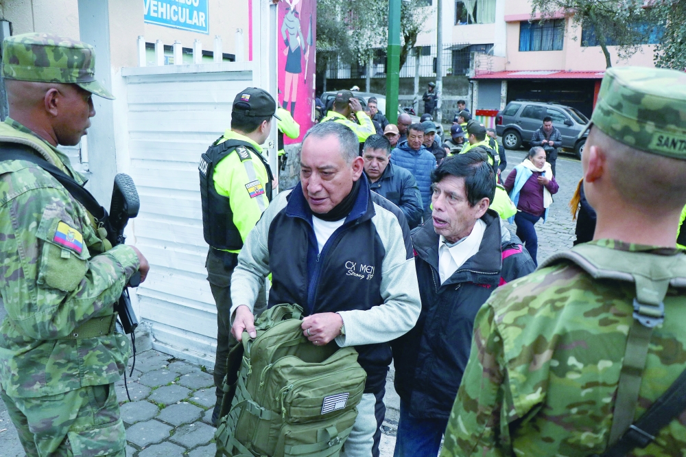 Ecuadorean soldiers stand guard at a polling station during the presidential runoff election in Quito. — AFP