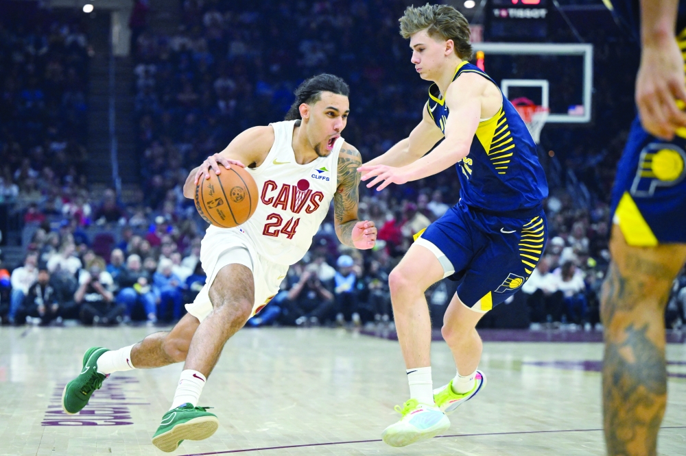 Cleveland Cavaliers forward Jaylon Tyson (24) dribbles beside Indiana Pacers forward Johnny Furphy (12) in the first quarter at Rocket Arena. — Reuters