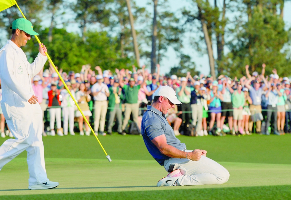 Northern Ireland's Rory McIlroy celebrates on the 18th green and 1st play-off hole after winning The Masters and completing a career grand slam REUTERS/Brian Snyder