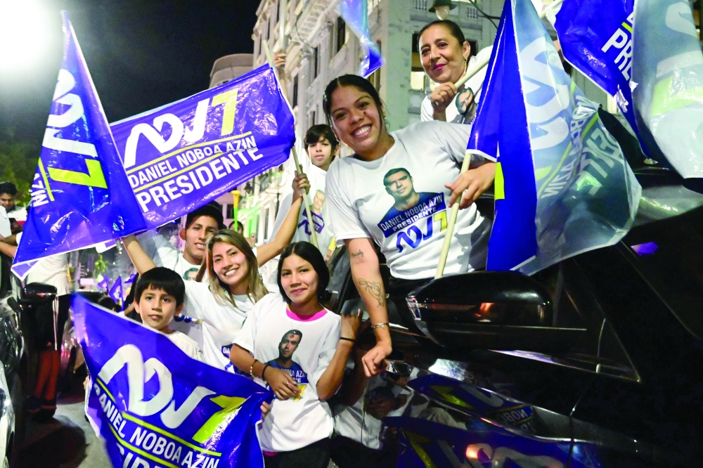 Supporters of Ecuador's President Daniel Noboa celebrate, at the Simon Bolivar Avenue in Guayaquil. — AFP