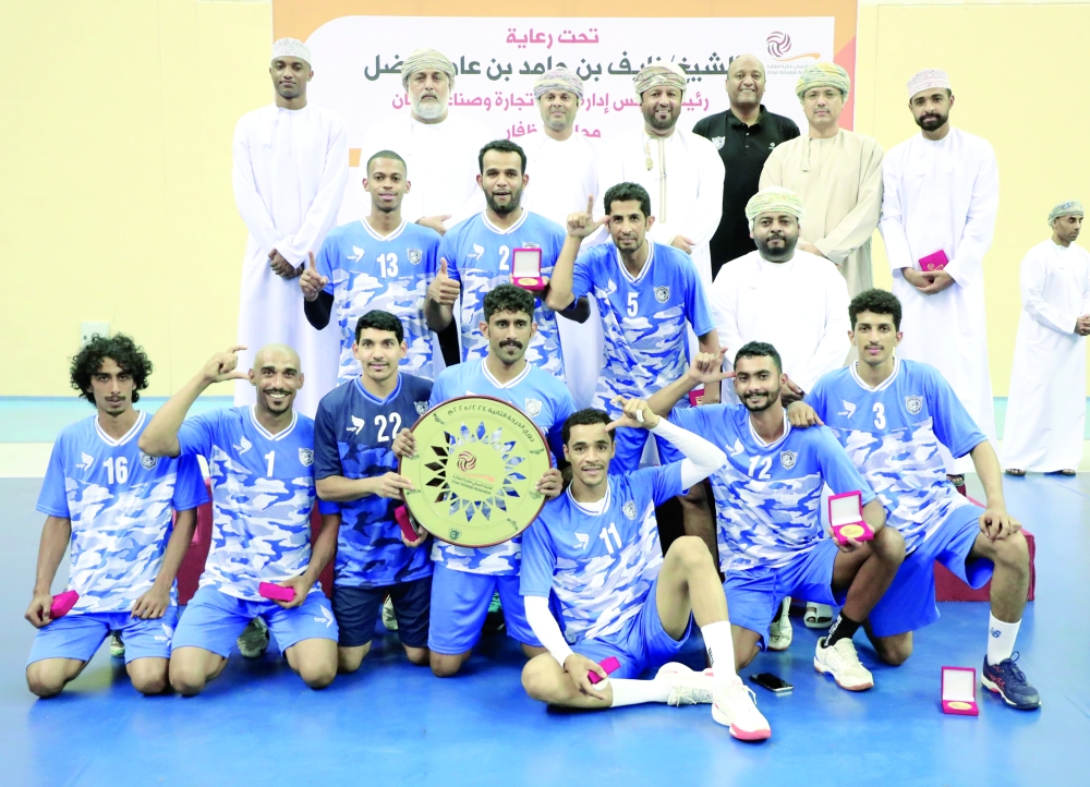 Salalah Club players celebrate with the trophy.