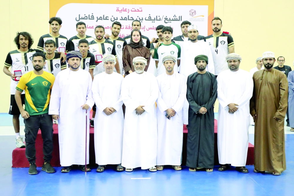 Taqah Club players pose with their awards.