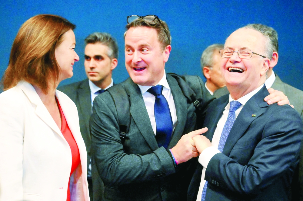 Palestinian Prime Minister Mohammad Mustafa is greeted by Slovenia's Minister for Foreign Affairs Tanja Fajon and Luxembourg's Foreign Minister Xavier Bettel ahead of the start of a European Union Foreign Affairs Council meeting at the European Convention Center Luxembourg in Luxembourg City. — AFP