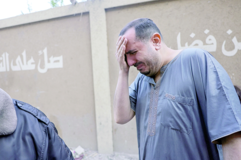 A Palestinian man cries as bodies of relatives are prepared for burial following overnight Israeli strikes on Jabalia's southwestern district of Nazla, that hit the Hessi family residence, in the northern Gaza Strip. — AFP