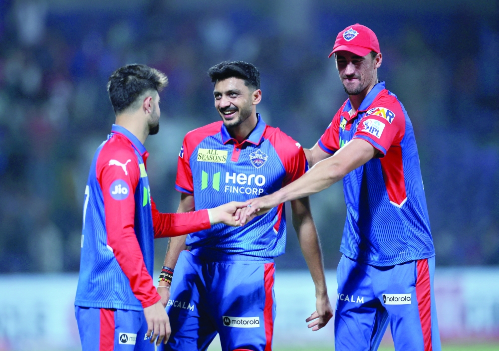 Delhi Capitals' Axar Patel and Mitchell Starc celebrate after the match. — Reuters
