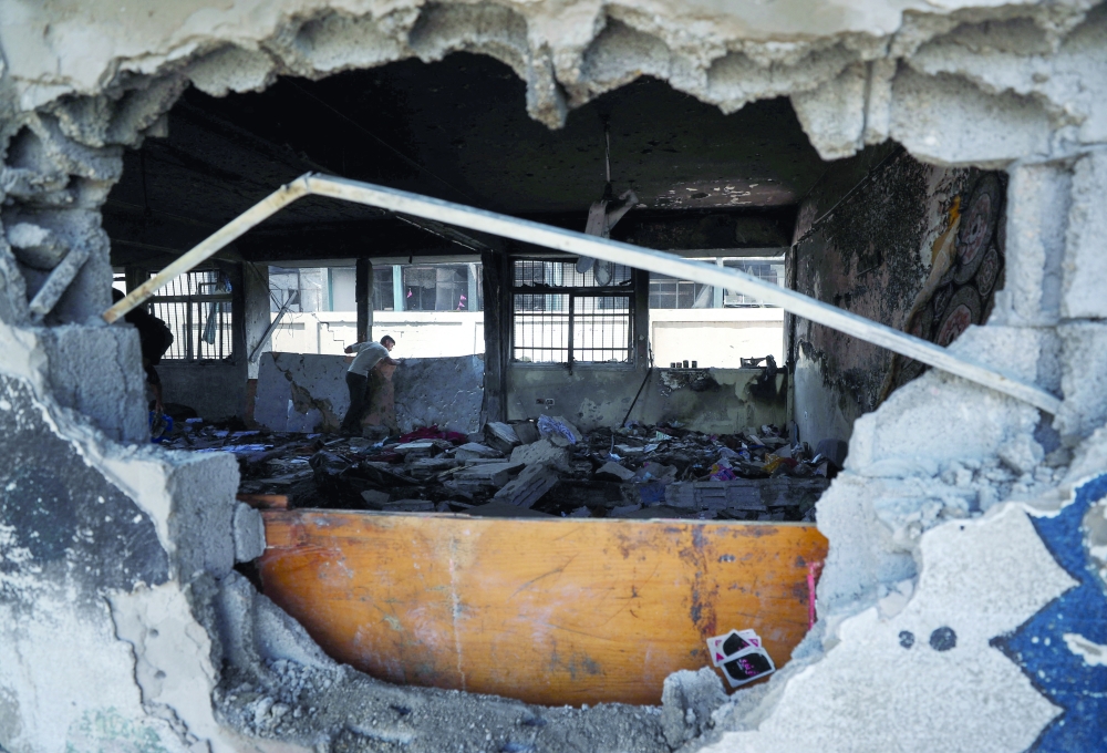 A Palestinian inspects the damage at a UN-run school sheltering displaced people, following an Israeli strike, at Jabalia refugee camp in the northern Gaza Strip. - Reuters