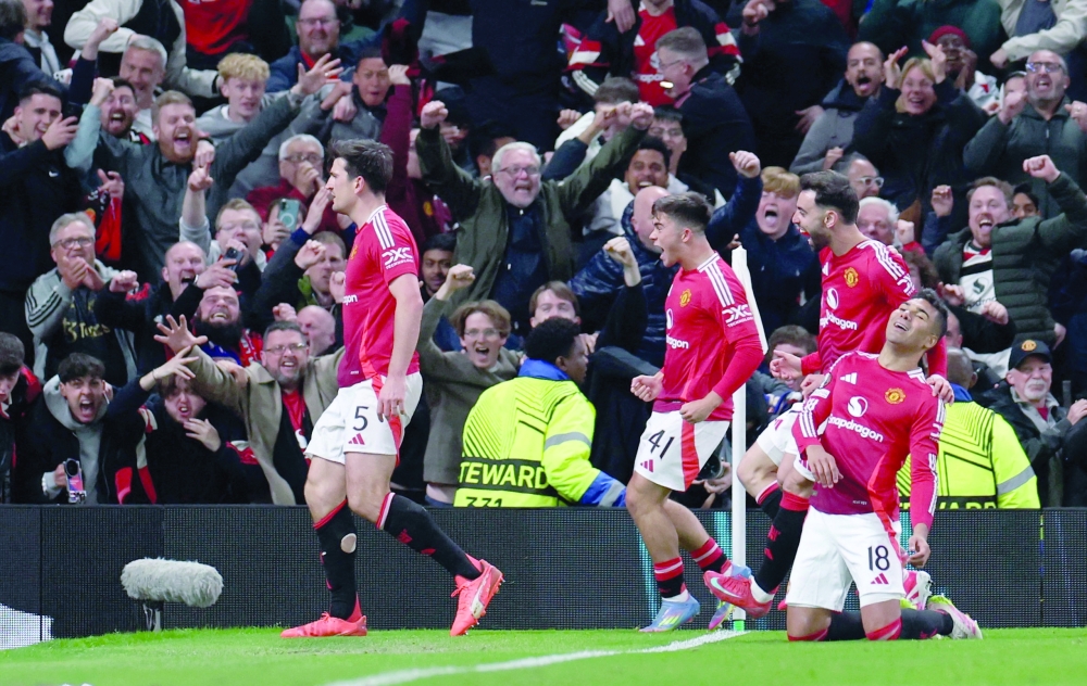 Soccer Football - Europa League - Quarter Final - Second Leg - Manchester United v Olympique Lyonnais - Old Trafford, Manchester, Britain - April 17, 2025 Manchester United's Harry Maguire celebrates scoring their fifth goal with teammates REUTERS/Phil Noble
