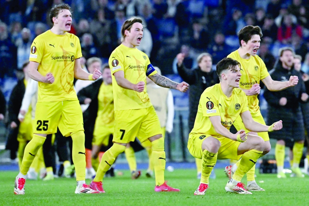 TOPSHOT - Bodo/Glimt's players celebrate during the penalty shout-out of the UEFA Europa League Quarter Final second leg football match between Societa Sportiva Lazio and Bodo/Glimt at Stadio Olimpico in Rome on April 17, 2025. (Photo by Filippo MONTEFORTE / AFP)

