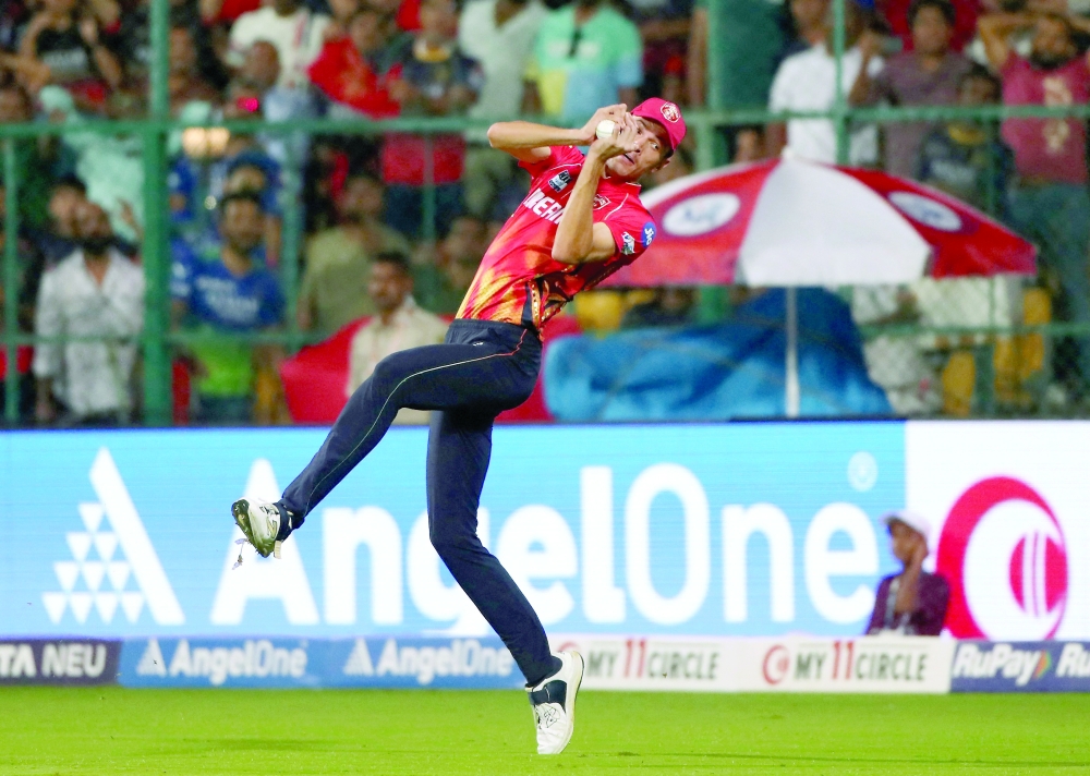 Punjab Kings' Marco Jansen takes a catch to dismiss Royal Challengers Bengaluru's Virat Kohli. — Reuters