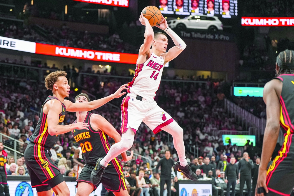 Miami Heat guard Tyler Herro (14) passes behind Atlanta Hawks guard Dyson Daniels (5) during the second half at State Farm Arena. — Reuters