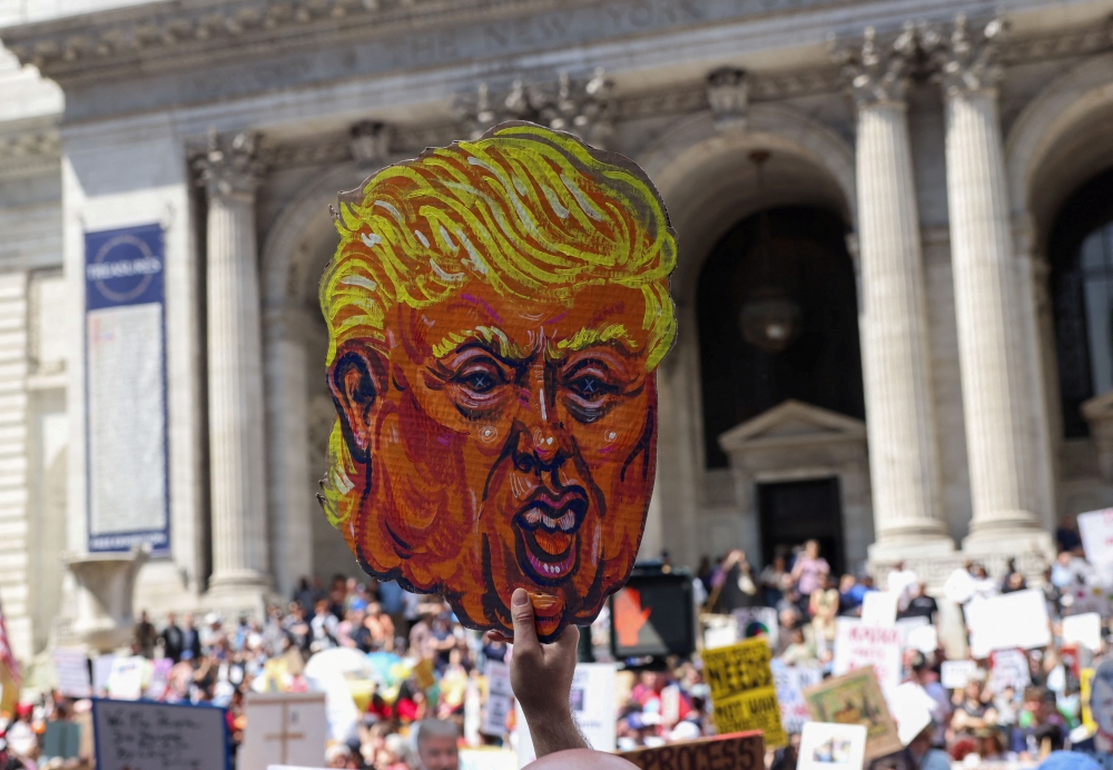 People take part in the "Protect Migrants, Protect the Planet” protest in New York City, U.S., April 19, 2025. 