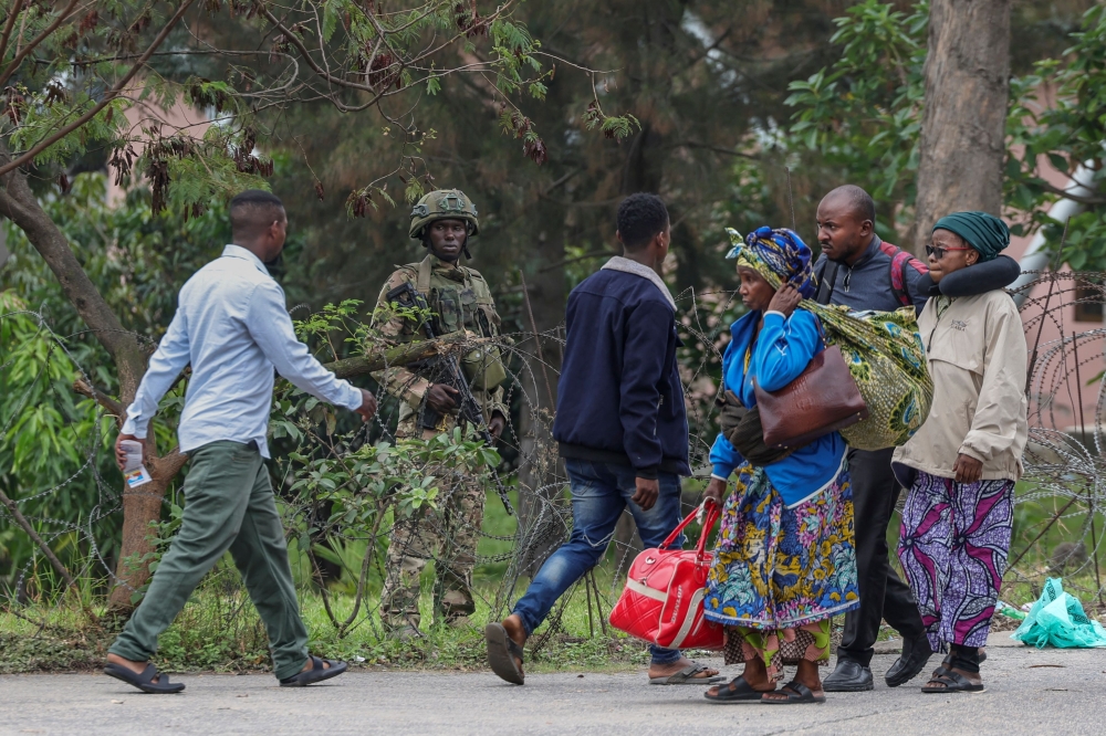 A member of the M23 armed group holds position as civilians fleeing ongoing clashes in eastern DRC. — AFP
