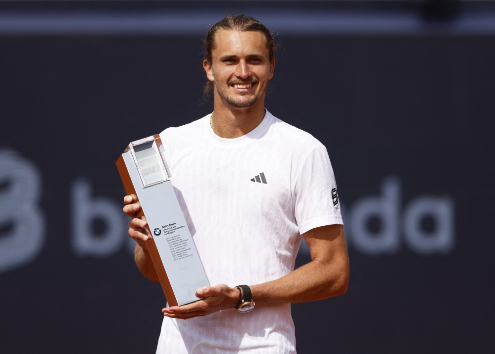 Germany's Alexander Zverev celebrates with the trophy after winning the Munich Open. — Reuters