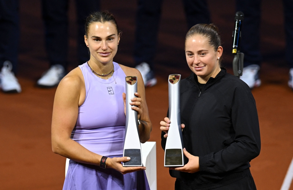 Winner Latvia’s Jelena Ostapenko (R) and Belarus’ Aryna Sabalenka pose with the trophies after the final match of the Women's Tennis Grand Prix WTA tournament in Stuttgart. — AFP