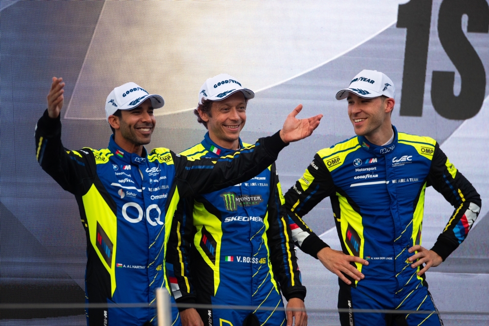 Ahmad al Harthy and teammates celebrate on the podium.