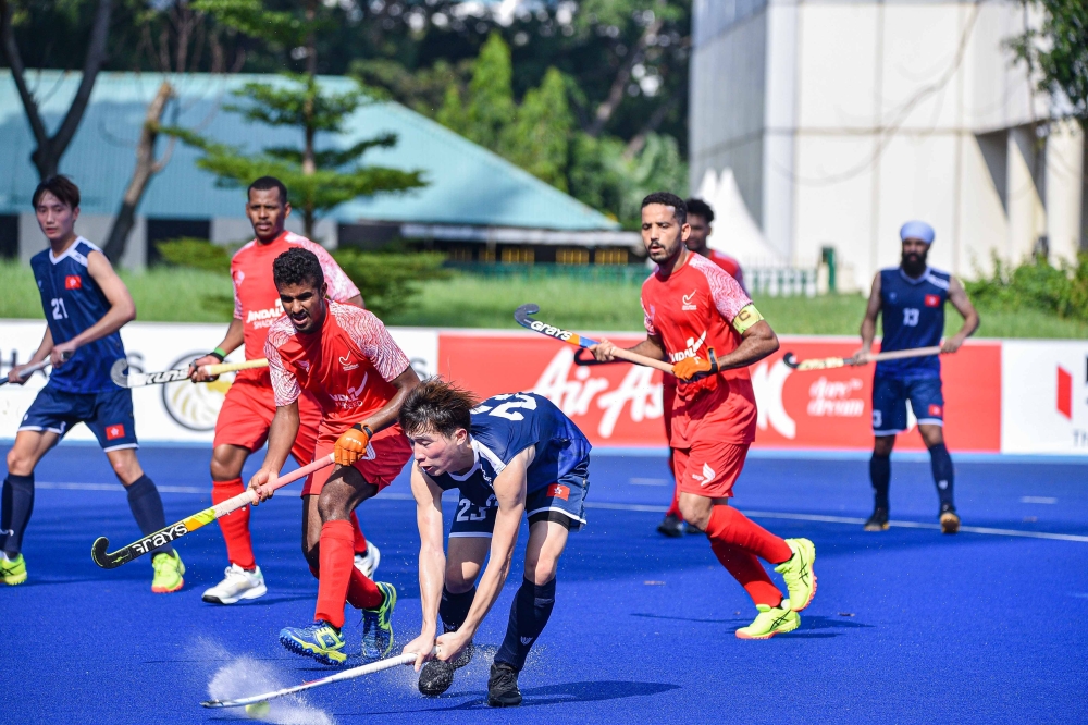 Oman and Hong Kong players in action.