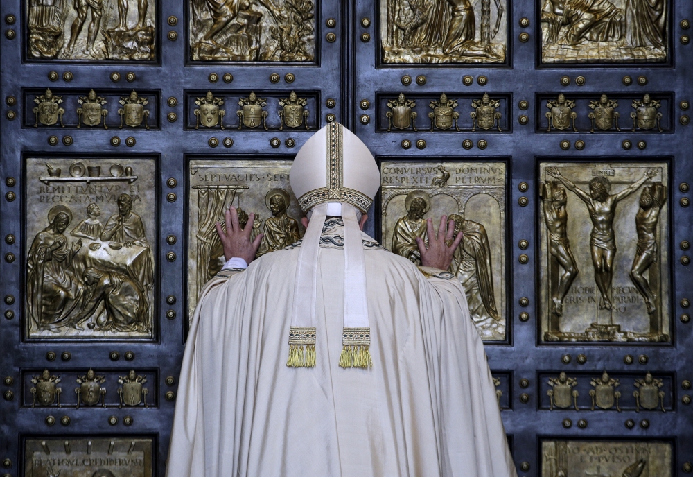 Pope Francis opens the Holy Door to mark the opening of the Catholic Holy Year, or Jubilee, in St. Peter's Basilica, at the Vatican. — Reuters