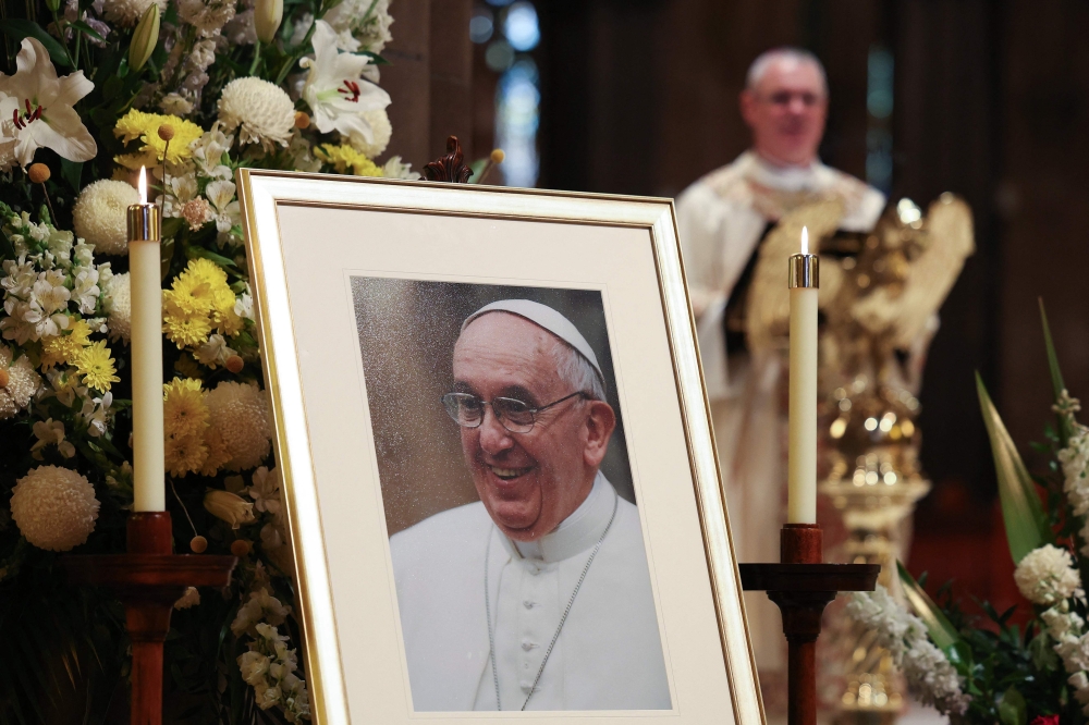 A photo of the late Pope Francis is displayed during mass at St Patrick's Cathedral in Melbourne