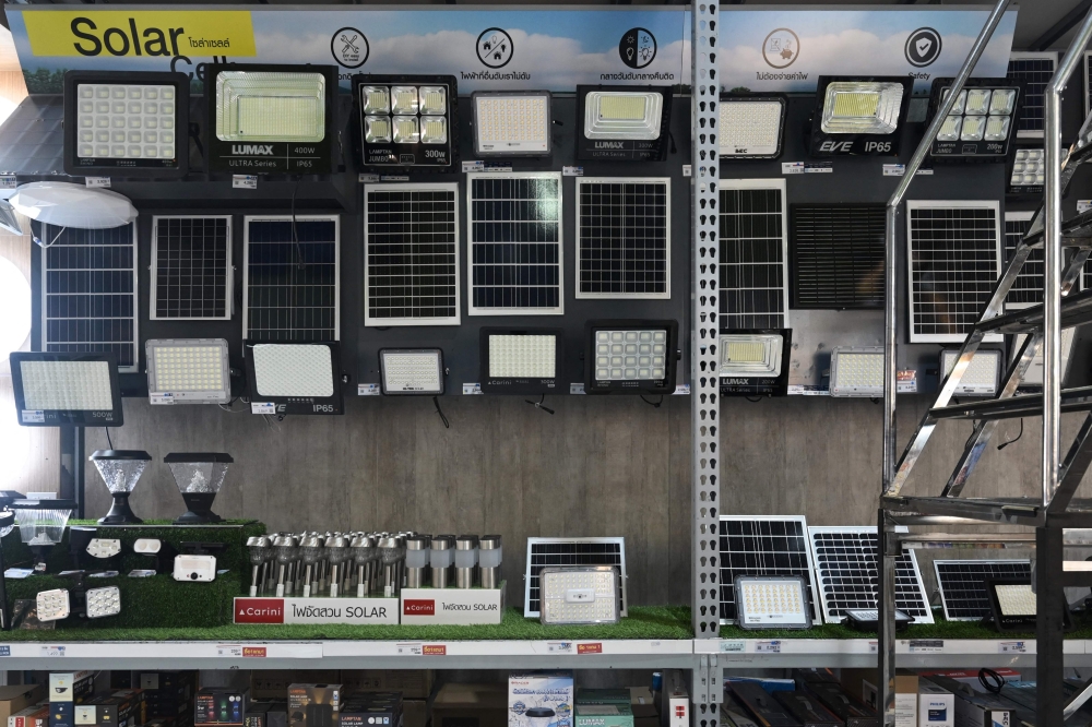  Small solar panels and solar-powered lights for sale at a home improvement centre in Bangkok