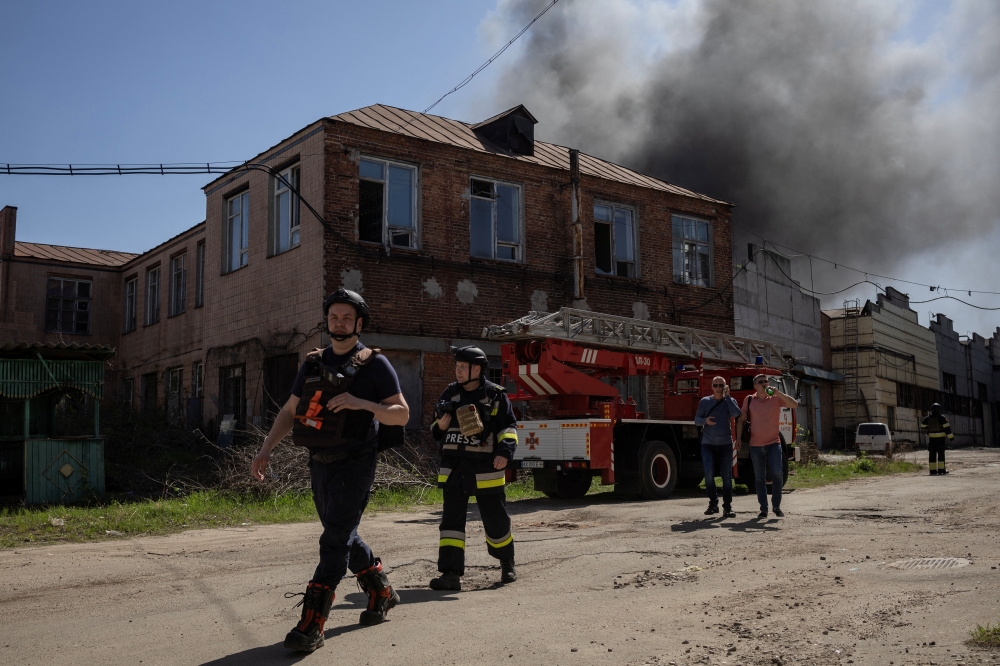 Ukrainian fireman walks at the site of a Russian drone strike, in Kharkiv. — Reuters