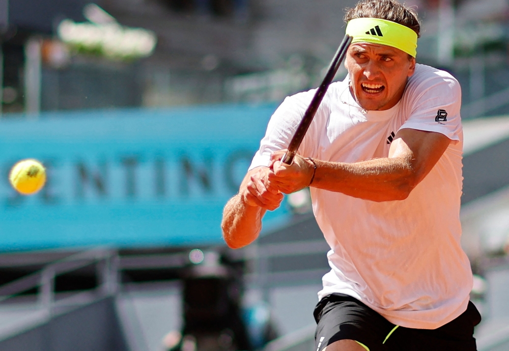 Germany's Alexander Zverev returns the ball to Spain's Roberto Bautista during their 2025 ATP Tour Madrid Open tennis tournament first round singles match at the Caja Magica in Madrid, on April 24, 2025.  (Photo by OSCAR DEL POZO / AFP)

