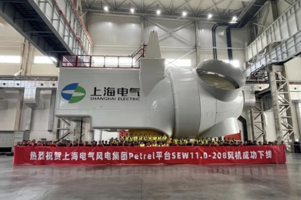  Workers of Shanghai Electric Wind Power pose with a wind turbine manufactured at one of the company’s Chinese plants
