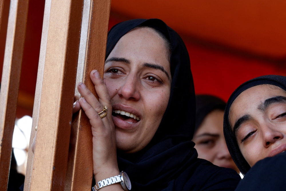 Women react near the bodies of Palestinians killed in Israeli strikes at Nasser Hospital, in Khan Younis, in the southern Gaza Strip. - Reuters 