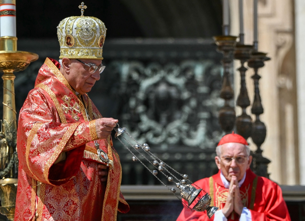 Youssef Absi, Patriarch of Antioch and All the Orient, of Alexandria and of Jerusalem and head of the Melkite Greek Catholic Church blesses with myrrhe the coffin of late Pope Francis, in front of Italian cardinal Giovanni Battista Re during the funeral ceremony at St Peter's Square at the Vatican on April 26, 2025.  (Photo by Alberto PIZZOLI / AFP)
