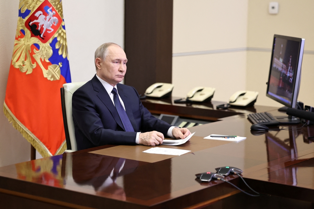 Russian President Vladimir Putin listens to General Gerasimov report, Moscow. — Reuters
