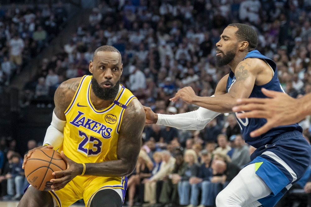 Los Angeles Lakers forward LeBron James (23) drives to the basket past Minnesota Timberwolves guard Mike Conley (10) in the first half during game three at Target Center. — Reuters