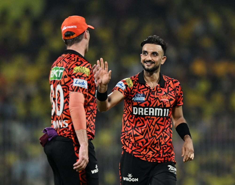 Sunrisers Hyderabad's Harshal Patel celebrates with Pat Cummins after taking the wicket of Chennai Super Kings' Noor Ahmad. — Reuters