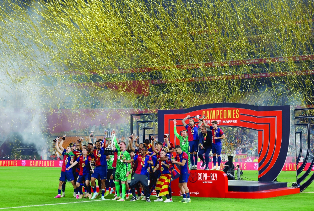 FC Barcelona's Marc-Andre ter Stegen and Ronald Araujo and team-mates celebrate with the trophy after winning the Copa del Rey. — Reuters